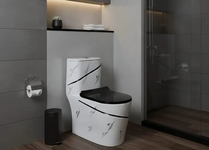 White marble one-piece toilet with black seat at Brazil Plumbing Center